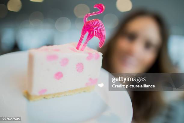 Model Jessica holds a piece of flamingo cheese cake with marshmellows during a press meeting for the world's largest food fair "Anuga" in Cologne,...