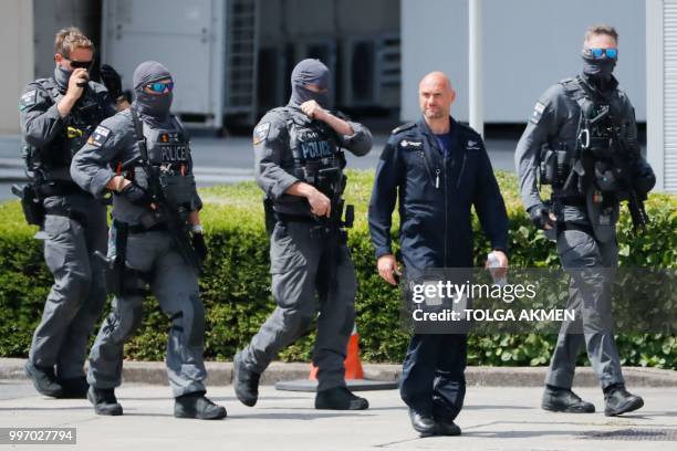 Armed police are seen on the tarmac at Stansted Airport, north of London on July 12 ahead of the arrival of US President Donald Trump on Air Force...