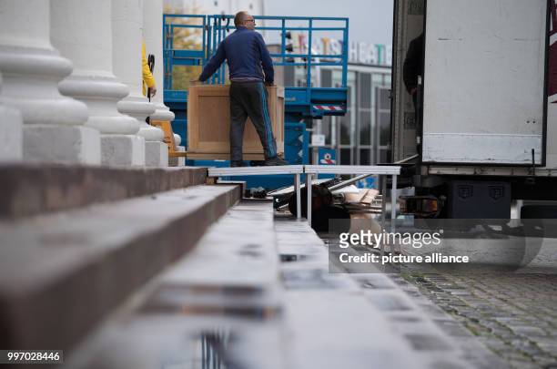 Worker pushes a box filled with documenta artwork into a truck in front of the Fridericianum in Kassel, Germany, 6 October 2017. The deconstruction...