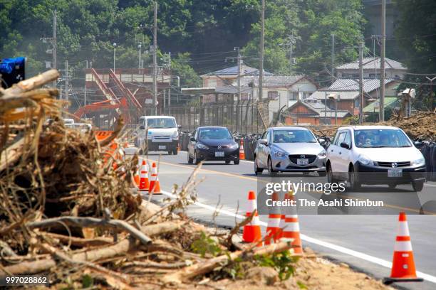 Cars run reopened the National Road 31, which connect Hiroshima and Kure cities on July 12, 2018 in Saka, Hiroshima, Japan. The death toll from the...