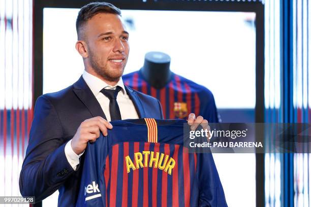 Barcelona's new player Brazilian midfielder Arthur Henrique Ramos de Oliveira Melo poses during his official presentation at the Camp Nou Stadium in...