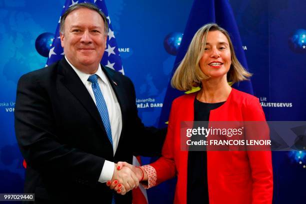 Secretary of State Mike Pompeo shakes hands with European Union's High representative for foreign affairs and security policy Federica Mogherini...