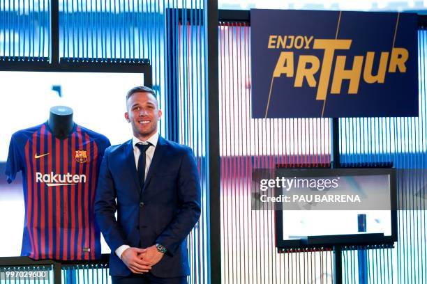 Barcelona's new player Brazilian midfielder Arthur Henrique Ramos de Oliveira Melo poses during his official presentation at the Camp Nou Stadium in...