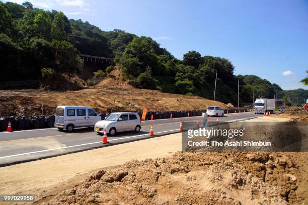 Cars run reopened the National Road 31, which connect Hiroshima and Kure cities on July 12, 2018 in Saka, Hiroshima, Japan. The death toll from the...