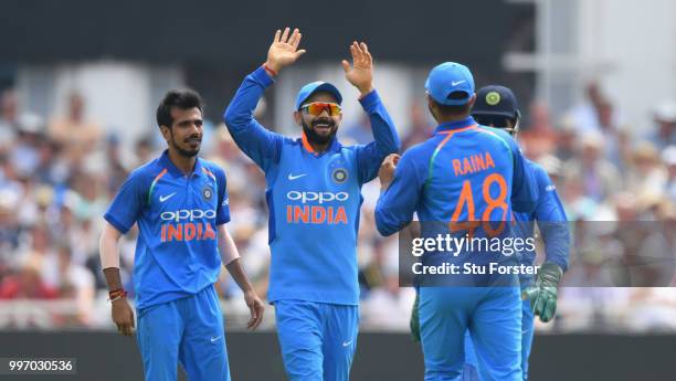 India captain Virat Kohli celebrates with team mates after Morgan had been dismissed by Chahal during the 1st Royal London One Day International...