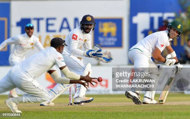 South Africa's Aiden Markram watches as Sri Lankan cricketer Angelo Mathews takes a catch to dismiss him during the first day of the opening Test...