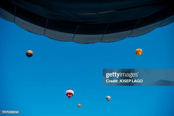 Hot-air balloons fly during the 22th European Balloon Festival in Igualada, near Barcelona on July 12, 2018. - The European Balloon Festival is the...