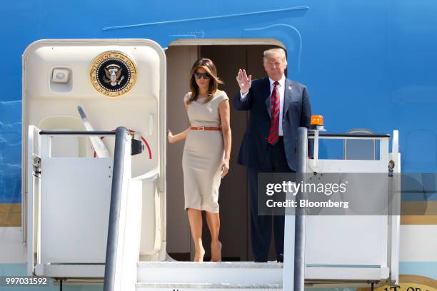 President Donald Trump waves as he disembarks from Air Force One with U.S. First Lady Melania Trump at London Stansted Airport in Stansted, U.K., on...