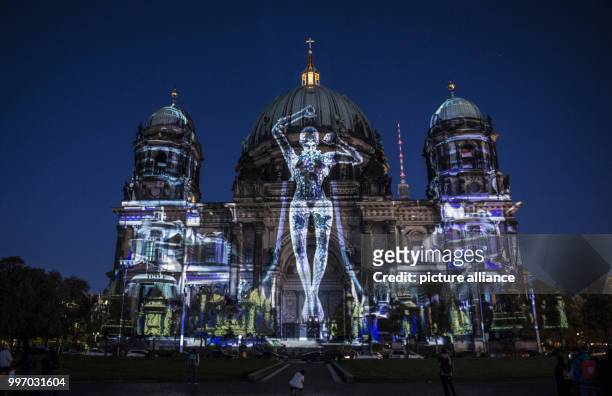 Dpatop - The Berlin Cathedral lit up ahead of the Festival of Lights in Berlin, Germany, 06 October 2017. Photo: Paul Zinken/dpa