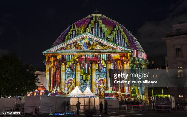 The St. Hedwig Cathedral lit up ahead of the Festival of Lights in Berlin, Germany, 06 October 2017. Photo: Paul Zinken/dpa