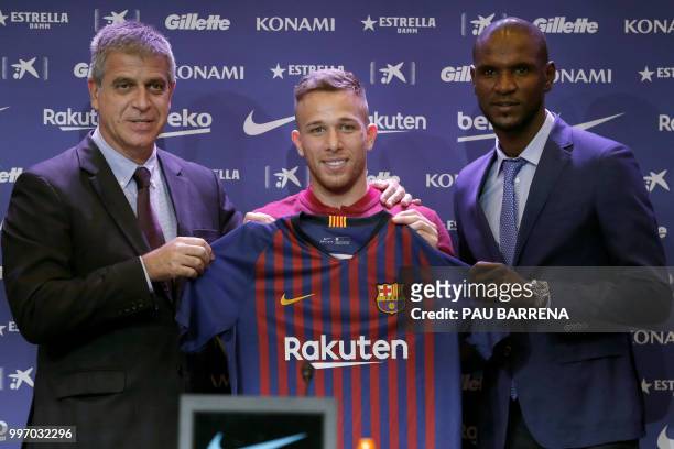 Barcelona's new player Brazilian midfielder Arthur Henrique Ramos de Oliveira Melo poses with Barcelona's vice-president Spanish Jordi Mestre and...