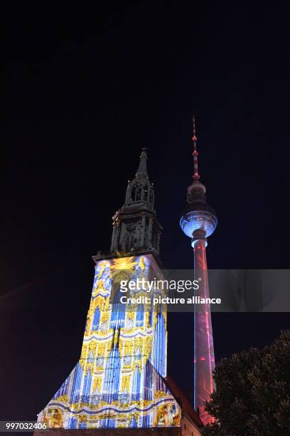 Berlin's St. Mary's Church and the TV Tower lit up ahead of the Festival of Lights in Berlin, Germany, 06 October 2017. Photo: Paul Zinken/dpa