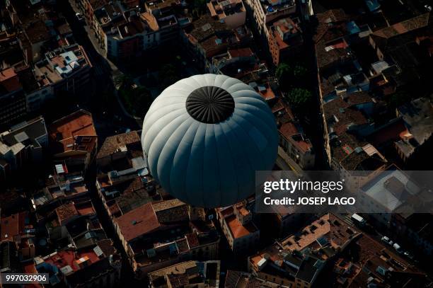 Hot-air balloons flies during the 22th European Balloon Festival in Igualada, near Barcelona on July 12, 2018. - The European Balloon Festival is the...