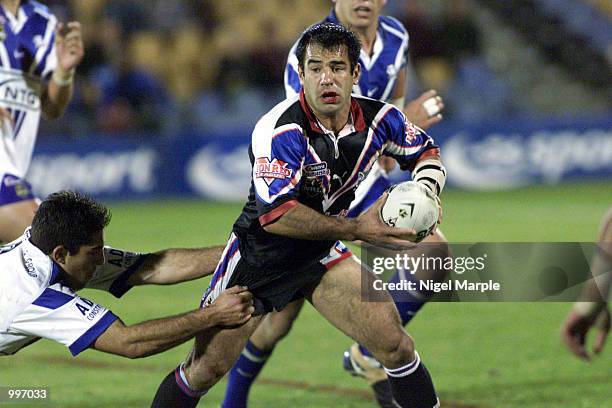 Warriors half back Stacey Jones looks to pass after being tackled by the Bulldogs Craig Polla Mounter during the game at Ericsson Stadium. Warriors...