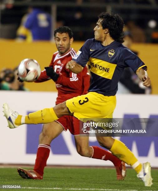 Tunisian club team Etoile Sahel defender Sabeur Frej controls the ball as Argentina club team Boca Juniors defender Claudio Morel attempts to block...
