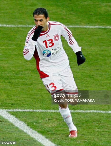 Sabeur Frej of Tunisia's club Etoile Sahel reacts after he scored a goal by penelty kick during the play-off for the third place against Japan's...