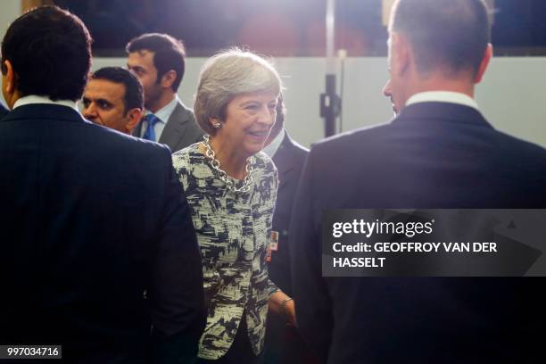 Britain's Prime Minister Theresa May attends the second day of the NATO summit, in Brussels, on July 12, 2018.