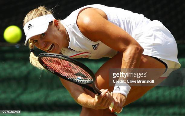 Angelique Kerber of Germany returns against Jelena Ostapenko of Latvia during their Ladies' Singles semi-final match on day ten of the Wimbledon Lawn...