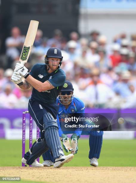 India wicketkeeper MS Dhoni looks on as England batsman Ben Stokes reverse hits the ball during the 1st Royal London One Day International match...