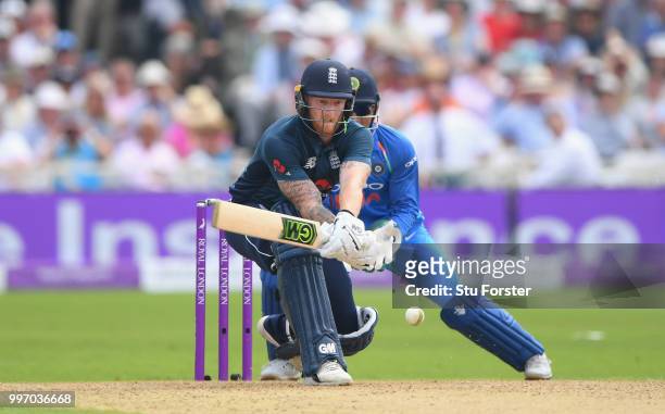 India wicketkeeper MS Dhoni looks on as England batsman Ben Stokes reverse hits the ball during the 1st Royal London One Day International match...
