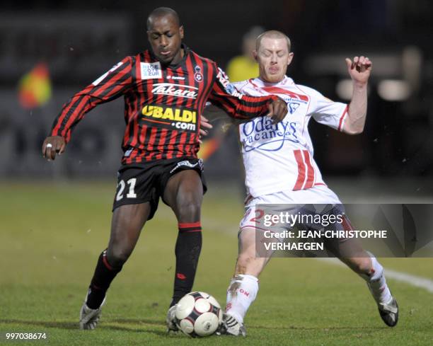 Nancy's midfielder Joanthan Brison fights for the ball with Nice's Nomwaya Bamogo during their French L1 football match Nancy vs. Nice at The Marcel...