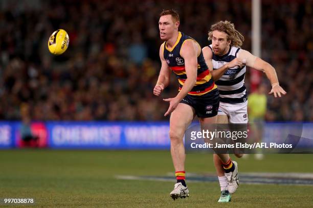 Tom Lynch of the Crows is tackled by Cameron Guthrie of the Cats during the 2018 AFL round 17 match between the Adelaide Crows and the Geelong Cats...