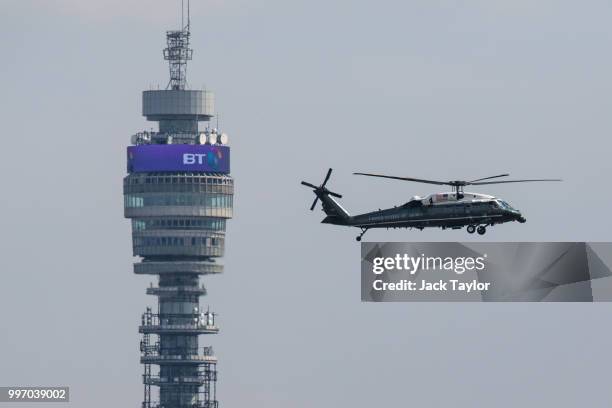 The Marine One helicopter carrying US President Donald Trump and First Lady Melania Trump flies past the BT Tower before landing at Winfield House,...
