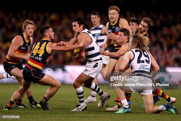 Lachlan Murphy of the Crows tackles Sam Simpson of the Cats during the 2018 AFL round 17 match between the Adelaide Crows and the Geelong Cats at...