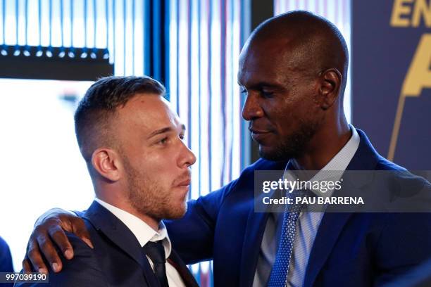 Barcelona's new player Brazilian midfielder Arthur Henrique Ramos de Oliveira Melo poses next to Barcelona's technical secretary French Eric Abidal...