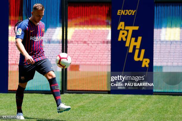 Barcelona's new player Brazilian midfielder Arthur Henrique Ramos de Oliveira Melo kicks the ball during his official presentation at the Camp Nou...