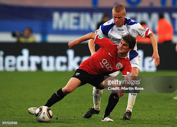 Andreas Dahlen of Rostock and Andreas Buchner of Ingolstadt compete for the ball for the ball during the Second Bundesliga play off leg two match...