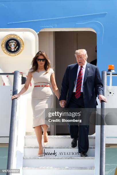 President Donald Trump, right, and U.S. First Lady Melania Trump disembark from Air Force One after arriving at London Stansted Airport in Stansted,...