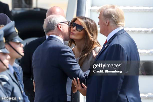 Woody Johnson, U.S. Ambassador to the United Kingdom, left, greets, U.S. First Lady Melania Trump, center, as U.S. President Donald Trump, looks on...