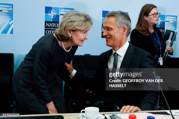 Secretary General Jens Stoltenberg greets NATO's US Ambassador Kay Bailey Hutchison on the second day of the NATO summit, in Brussels, on July 12,...
