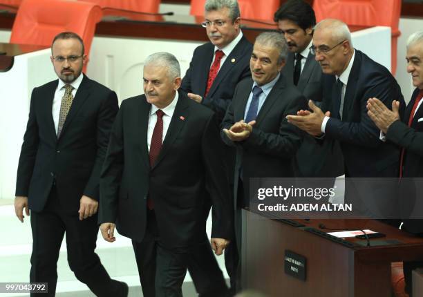 Turkey's last Prime Minister Binali Yildirim from the ruling Justice and Development Party, is applauded after casting his vote in the first round of...