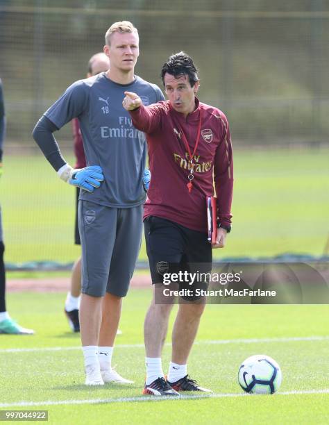 Arsenal Head Coach Unai Emery with goalkeeper Bernt Leno during a training session at London Colney on July 12, 2018 in St Albans, England.