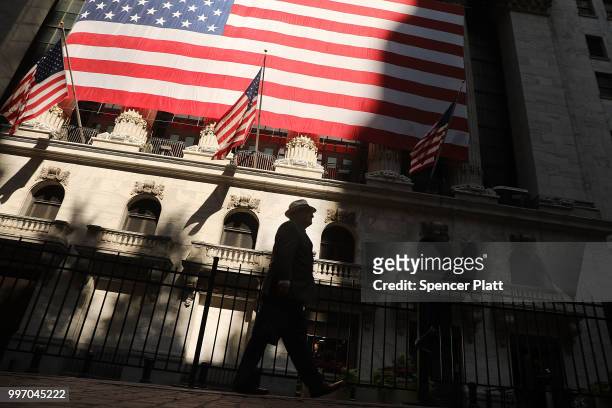 Man walks by the New York Stock Exchange on July 12, 2018 in New York City. As fears of a trade war eased with China, the Dow Jones Industrial...