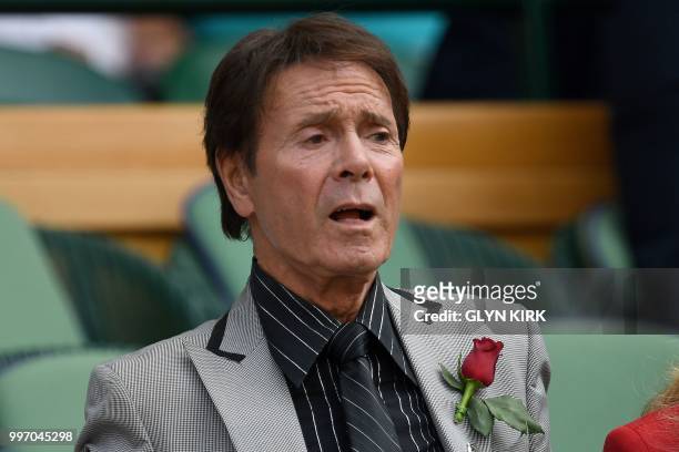 British musician Cliff Richard sits on centre court before watching US player Serena Williams play Germany's Julia Goerges during their women's...