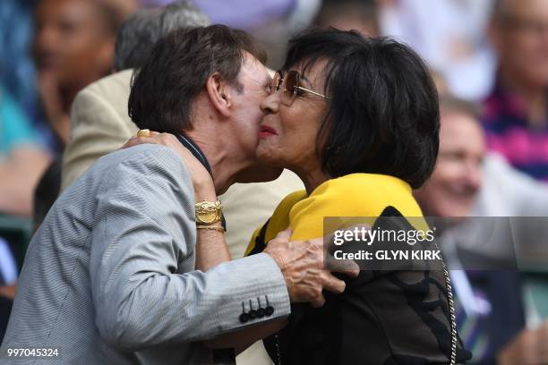 British musicians Cliff Richard and Shirley Bassey embrace on centre court before watching US player Serena Williams play Germany's Julia Goerges...