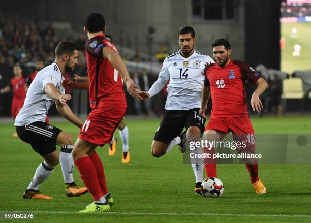 Germany's Shkrodran Mustafi and Emre Can and Azerbaijan's Javid Huseynov vie for the ball during the World Cup Group C quailification soccer match...