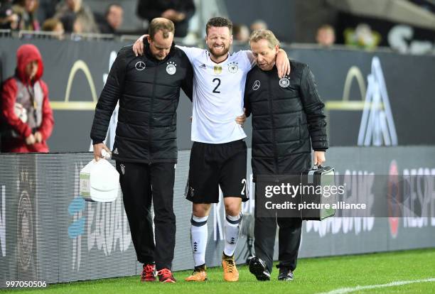 Injured Shkodran Mustafi leaves the pitch during the World Cup Group C quailification soccer match between Germany and Azerbaijan at the Fritz Walter...