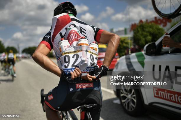 Colombia's Darwin Atapuma stacks water bottles for his teammates during the sixth stage of the 105th edition of the Tour de France cycling race...