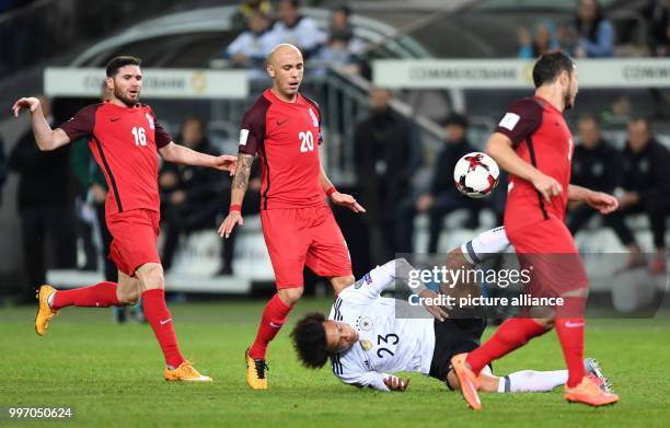 Germany's Leroy Sane and Azerbaijan's Javid Huseynov , Richard Almeida and Magomed Mirzabekov vie for the ball during the World Cup Group C...