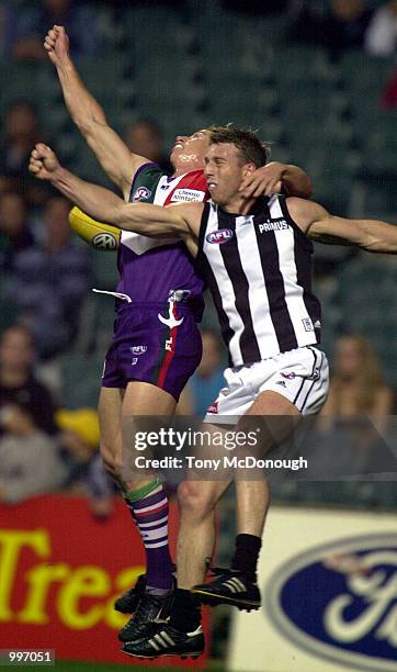 Glenn Freeborn for Collingwood knocks the ball away from Shaun McManus for Fremantle, in the match between the Fremantle Dockers and the Collingwood...