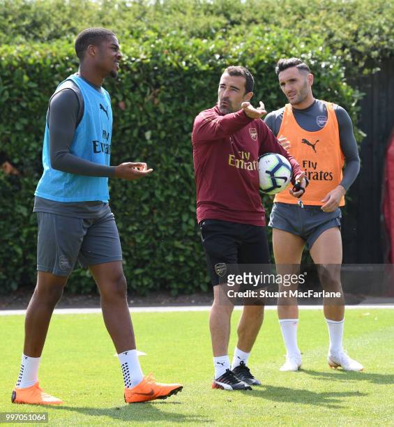 Arsenal assistant coach Juan Carlos Carcedo with Chuba Akpom and Lucas Perez during a training session at London Colney on July 12, 2018 in St...