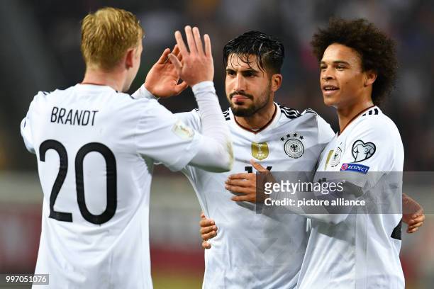 Germany's Emre Can celebrating with Julian Brandt and Leroy Sane the 5:1 during the World Cup Group C soccer qualifier match between Germany and...