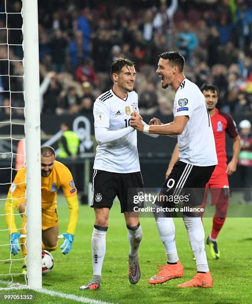 Germany's Leon Goretzka with Leroy Sane celebrating the 4:1 during the World Cup Group C soccer qualifier match between Germany and Azerbaijan at the...