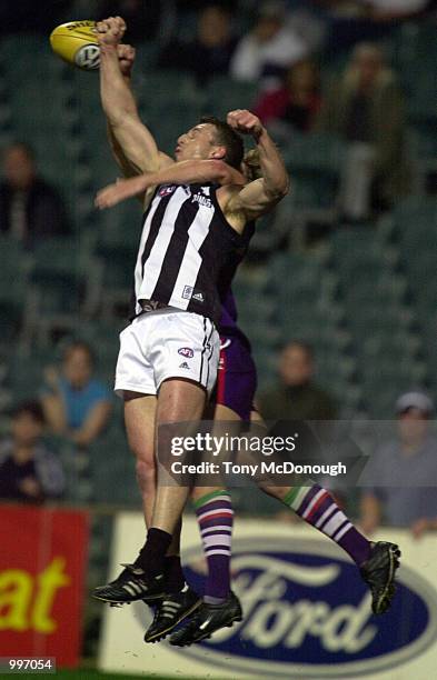 Glenn Freeborn for Collingwood knocks the ball from Shaun McManus for Fremantle, in the match between the Fremantle Dockers and the Collingwood...