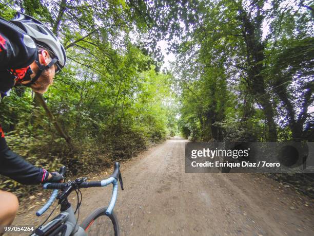 riding a bicycle on the dirt road, wormley,england. - 7cero stock pictures, royalty-free photos & images