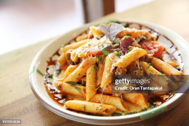 penne pasta in tomato sauce with meatballs - tomato pasta stock pictures, royalty-free photos & images